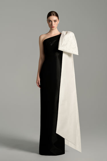 Black taffeta column gown with asymmetric white shoulder bow and delicate crystal embellishments - IHF STUDIO