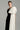 Black taffeta column gown with asymmetric white shoulder bow and delicate crystal embellishments - IHF STUDIO