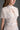 White Architectural Lace Bustier A-Line Dress With Mini Cape And Crystal Embellishment - IHF STUDIO