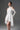 White Floral Vine Lace Mini Mullet Dress With Halter Neck And Long Sleeves