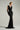 Black shimmer jersey maxi dress with a draped cowl neckline and delicate embellishments - IHF STUDIO