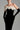 Black velvet column gown with sculpted white silk roses and an off-shoulder neckline - IHF STUDIO
