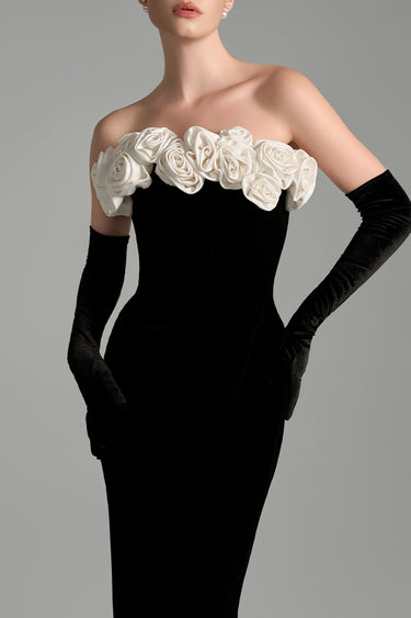 Black velvet column gown with sculpted white silk roses and an off-shoulder neckline - IHF STUDIO