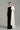 Black taffeta column gown with asymmetric white shoulder bow and delicate crystal embellishments - IHF STUDIO
